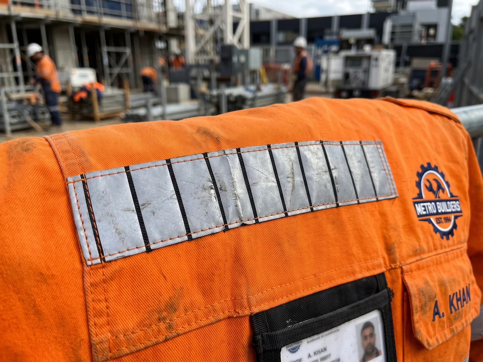 Close-up of segmented reflective tape on an orange hi-vis jacket